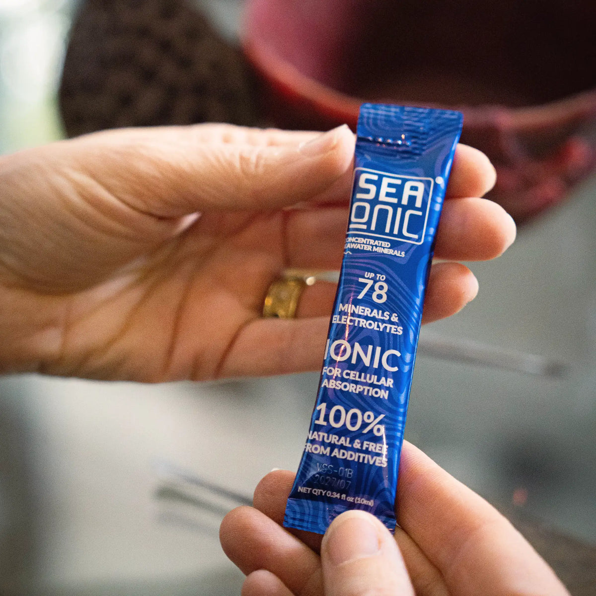 Hand holding a single Seaonic Hypertonic sachet to show its size